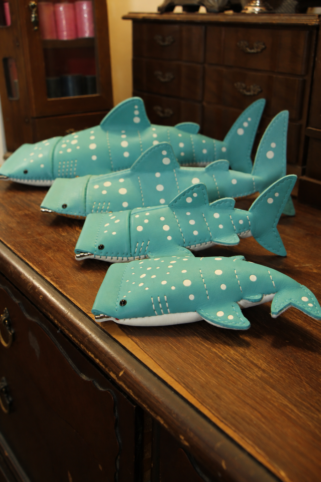 Baby Whale Shark Wallet displayed with three larger whale shark leather designs