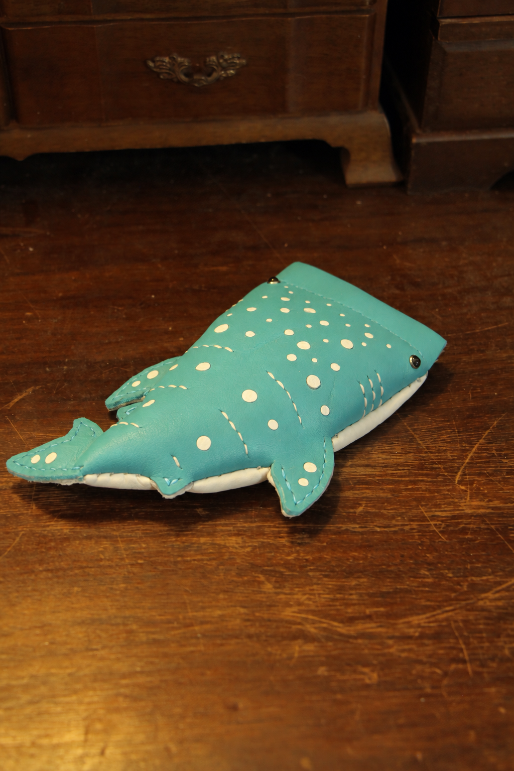 Turquoise Baby Whale Shark Wallet showing its spotted leather body and stitched fins
