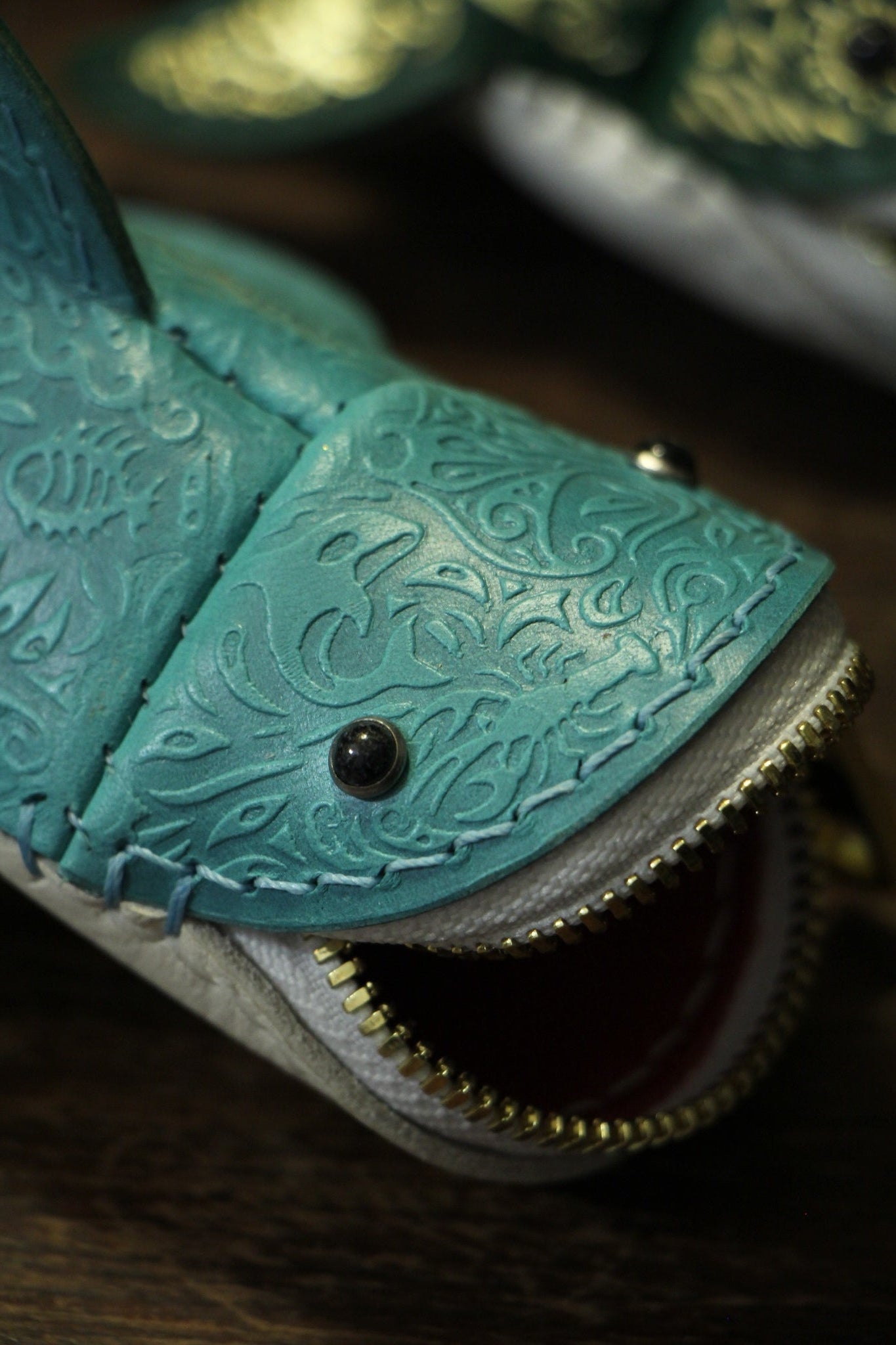 Close-up of Embossed Shark face, zipper and eye detail